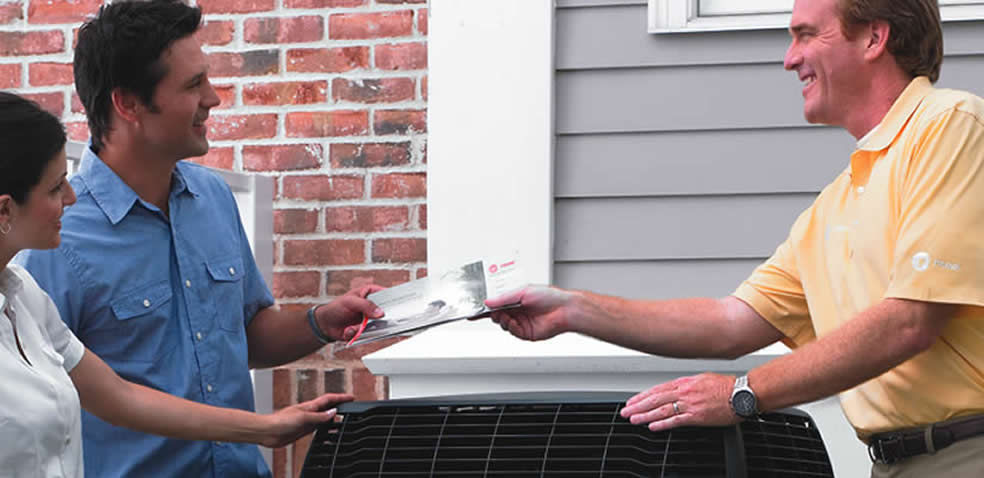 trane dealer handing brochure to customers